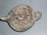 a clay pot that has a picture of a man in a boat on it