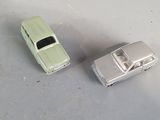 two toy cars sitting next to each other on a table