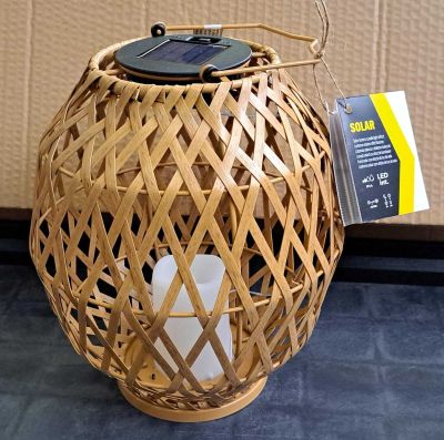 une lanterne en osier surmontée d'un panneau solaire