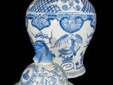 two blue and white vases sitting next to each other