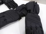 a pair of black motorcycle gloves on a white table