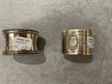 two silver napkins and a napkin holder on a table