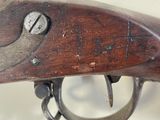 a close up of a rifle that is on display