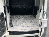 a white van with a mattress in the back of it