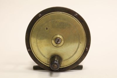 a small metal object on a stand on a white surface