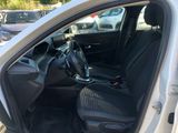 the interior of a car with the door open and the driver ' s seat down