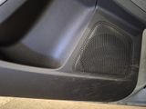 a close up of a car door with a speaker in it