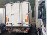 two trucks parked next to each other in a parking lot