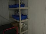 a room with a shelf and a red chair in it