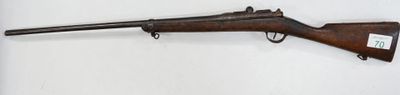 a rifle mounted on a wall with a white background