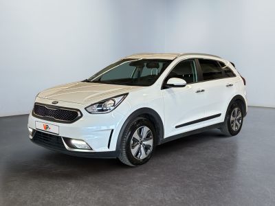 a white car parked in a room with a black floor