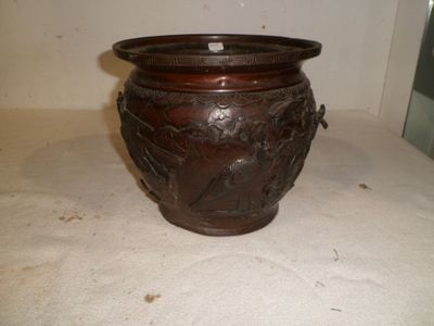 a brown vase sitting on a table with a white background