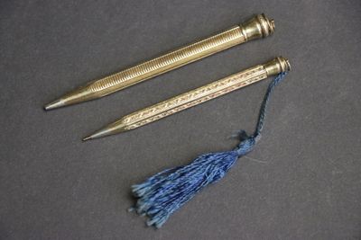deux stylos et un pompon posés côte à côte sur une table