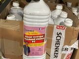 a person holding a bottle of cleaner next to a box of bottles