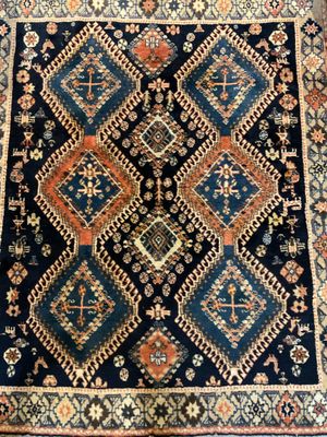 a blue and orange rug with a diamond design on it