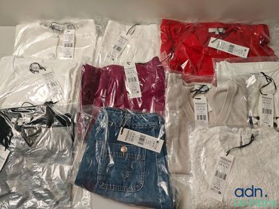 several pairs of men ' s t - shirts in plastic bags on a table