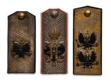 three different types of metal plaques on a white background