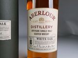 a bottle of whisky sitting next to a bottle of white oak