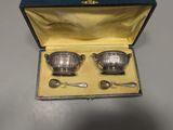 two silverplated dishes and spoons in a blue case