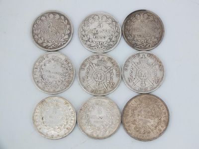 six different types of silver coins sitting on a white surface
