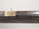 a wooden bench with a plaque on the top of it