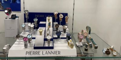 a lot of watches on display in a glass case