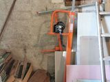 a pile of assorted items in a room with a ladder