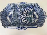a blue and white plate with a decorative design on it