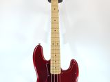 an image of a red bass guitar on a stand against a white background