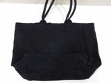 a black tote bag hanging from a hook on a wall