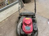 a lawn mower that is sitting on the ground
