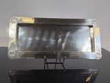 two silver trays sitting on top of a black table