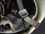 a helmet with a belt on it sitting on a table