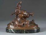 bronze statue of a man on a horse with a bird on his back