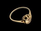 a close up of a gold ring on a black background