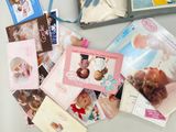 many cards and pictures on a table with a blue ribbon