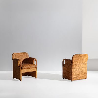 a pair of rattan chairs in the style of person