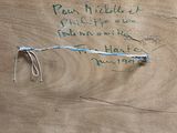 a piece of wood that has writing on it