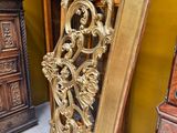 une grande porte en bois dans un coin d'une pièce, à côté d'une commode
