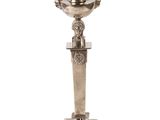 a silver cup on a pedestal on a white background