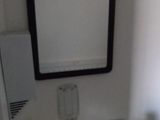 a white sink in a small bathroom with a mirror above it