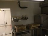 a picture of a kitchen with a number sign hanging from the ceiling