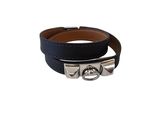 a close up of a black leather bracelet on a white background