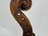 a close up of a violin that is sitting on a table