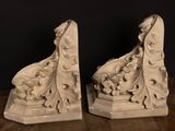 pair of white marble bookends with floral designs on them