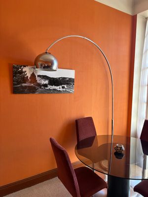 a table and chairs in a room with orange walls