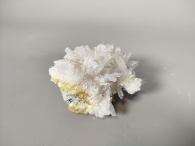 a small piece of white crystals on a white surface
