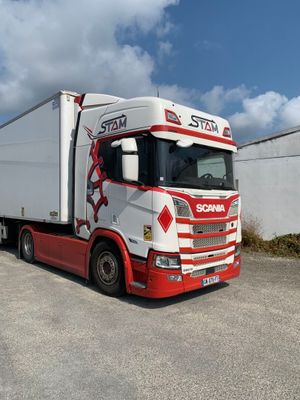 a white and red semi truck parked in a parking lot