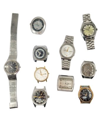 a lot of watches that are sitting together on a white surface