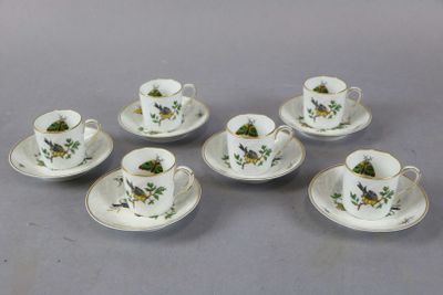 six cups and saucers with flowers on them sitting on a table